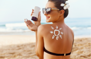 Woman Applying Sun Cream on Shoulder