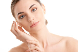 A woman touching her cheek after Thermage® FLX in Mount Pleasant