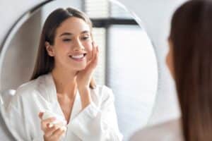 An Upneeq® user applying makeup
