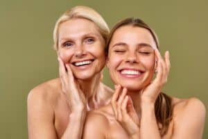 Two women looking in the mirror after Celluma in Mount Pleasant, SC