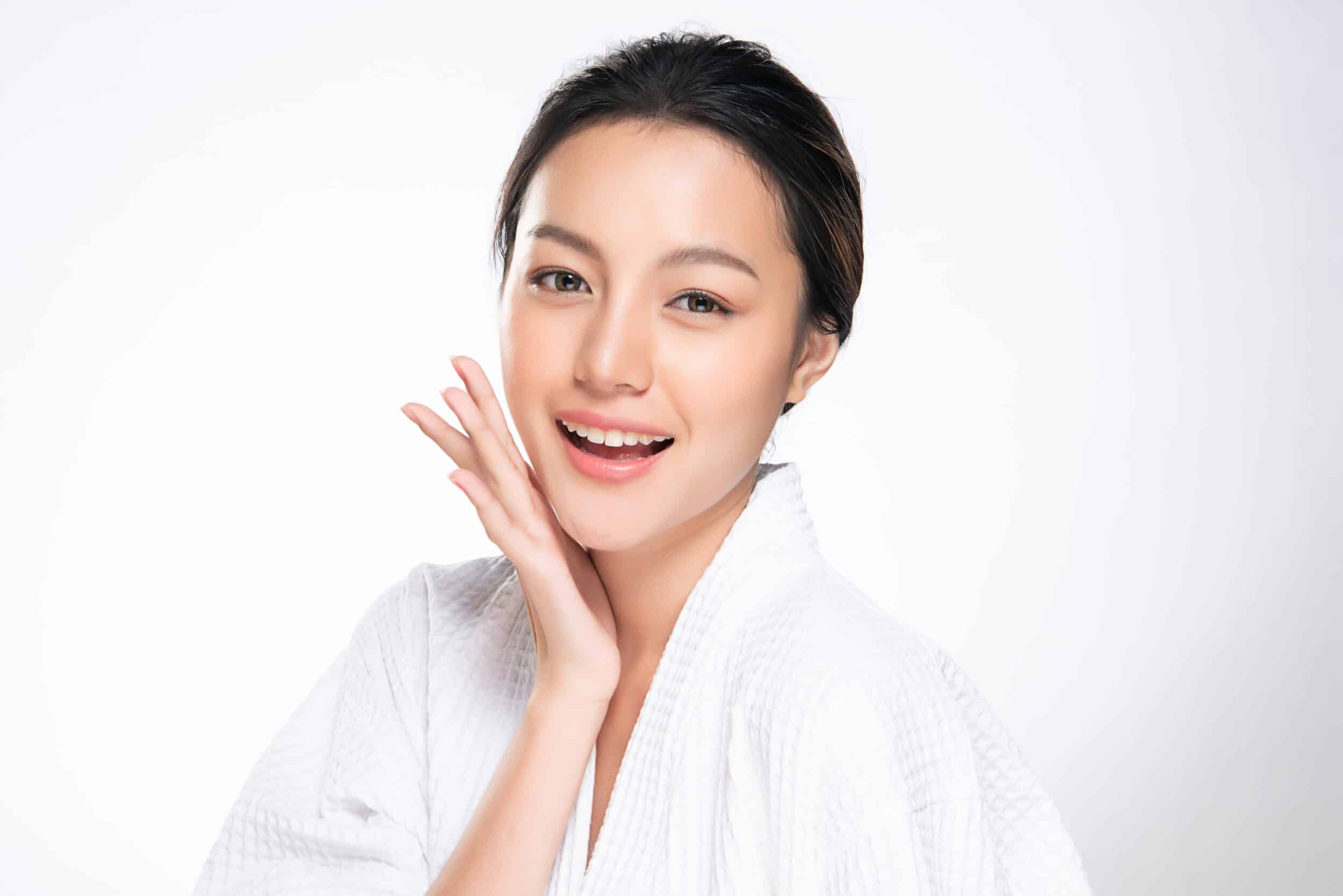 A woman touching her cheek after a DEKA DOT fractional laser treatment A woman touching her cheek after a DEKA DOT fractional laser treatment