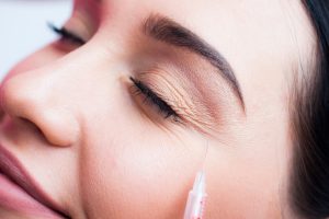 A woman closing her eyes while getting BOTOX with PRO-NOX sedation